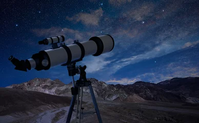 Poster telescope on a tripod pointing at the night sky © Paulista