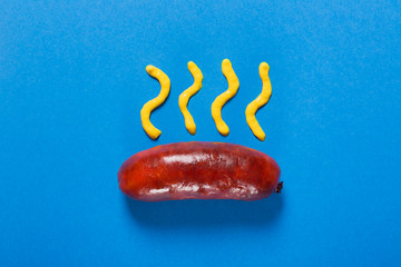 Grilled sausages prepared on grill. Blue background. Concept