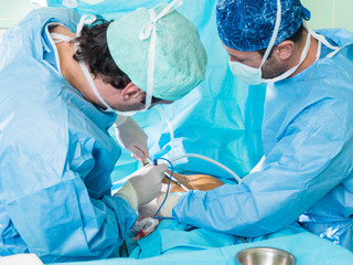 Real surgery team in the operating room. Photos from a live session of breast augmentation surgery.