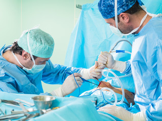 Real surgery team in the operating room. Photos from a live session of breast augmentation surgery.