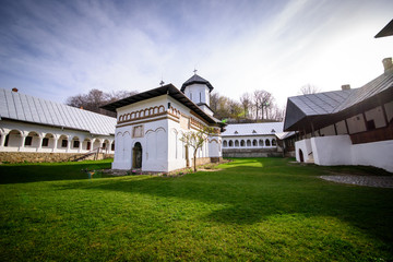 Fototapeta na wymiar Orthodox monastery courtyard with church and monk rooms