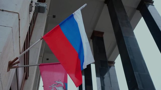 National flag of Russian Federation and Moscow on the house background