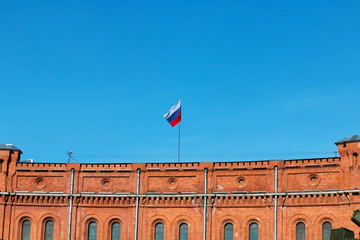 Russia flag on a brick building.