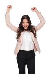 excited business woman with hands in the air screaming