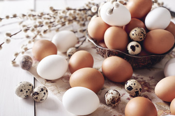 Three different kind of eggs on table .