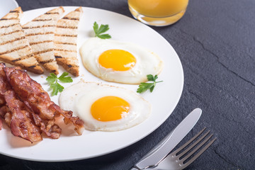 Breakfast with eggs bacon and toasts