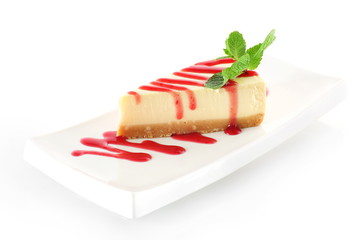 cheesecake with mint leaves on a white background