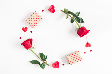 Valentine's Day. Round frame made of rose flowers, gifts, candles, confetti on white background. Valentines day background. Flat lay, top view, copy space