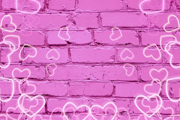 Beautiful pink against a brick wall with hearts. The concept of the Holy day of valetine