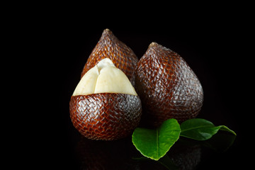 snake fruit on a black background. beautiful edible exotic fruits. food for vegans
