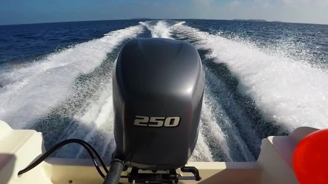 Powerful Boat Engine Cuts a Foamy Wake behind Tour Boat