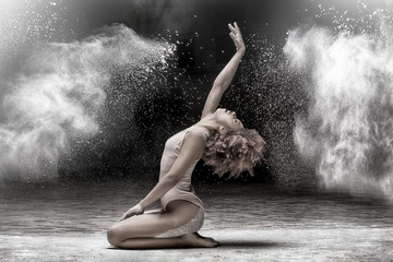 Beautiful dancer performing in dust.