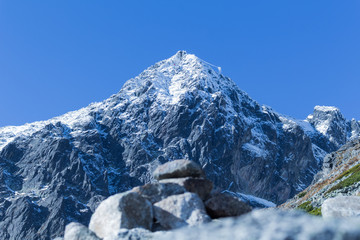 Winter landscape of snow mountain range and blue sky. Scenery background for mountain activities such as skiing trekking winter