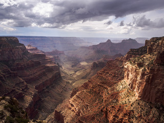 The sun sparkeling through the clouds during a thunderstorm over the Grand Canyon