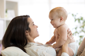 Mother and baby son laughing and playing