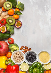 Healthy vegan food concept. Fruits vegetables background. Fresh vegetables, exotic and seasonal fruits, cereals, nuts and beans for a vegetarian diet, top view. Copy space, frame background.