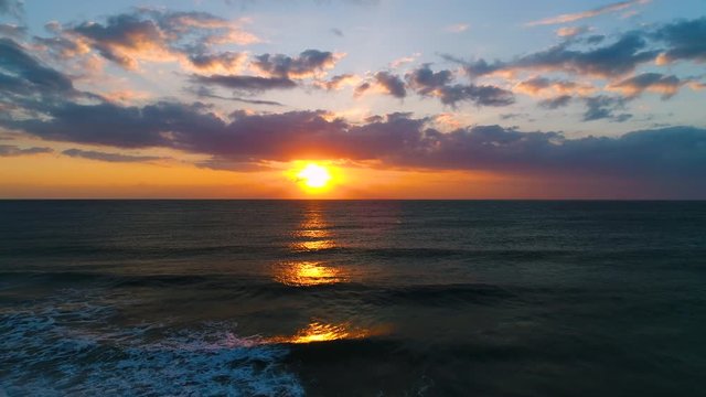 Aerial view of beautiful sunrise with dramatic cloudscape over the sea video