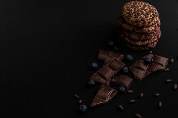 Black biscuits with chocolate and blueberries