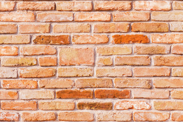 Wallpaper of a red antique brick wall with colored bricks