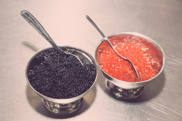 Appetizer of caviar on a metal table of restaurant kitchen. Selective focus. Shallow depth of field. Toned