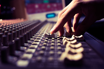 male sound engineer hands working on sound mixer for recording, broadcasting, music production...