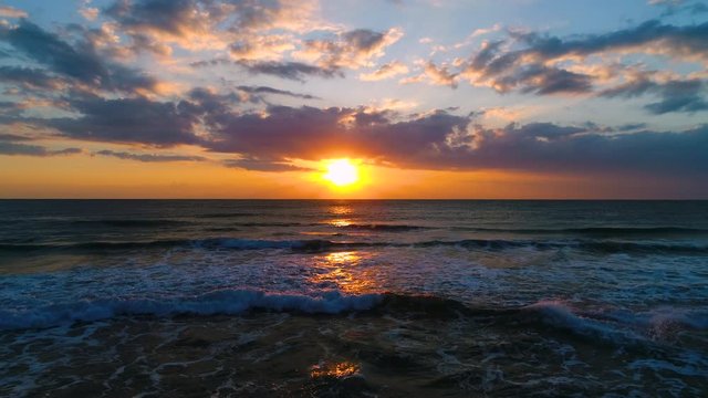 Aerial view of beautiful sunrise with dramatic cloudscape over the sea video