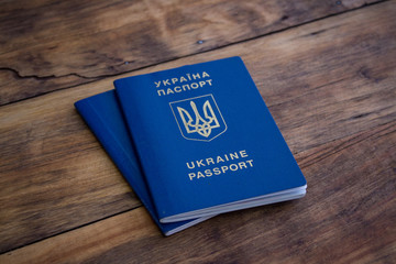 Two passports on a wooden background. Concept of Travel