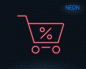 Neon light. Shopping cart with Percentage line icon. Online buying sign. Supermarket basket symbol. Glowing graphic design. Brick wall. Vector