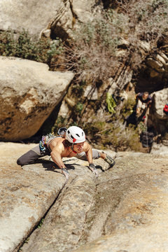 Rock climber ascending a steep granite crack in la Pedriza, Madrid
