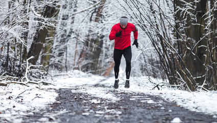 Winter running training, runner at cold snow weather