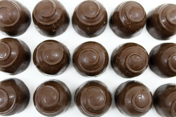 Round chocolate candy isolated on white background.