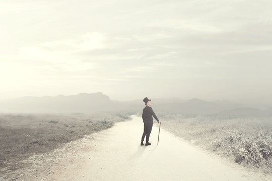 elegant man walks thoughtfully over a deserted road