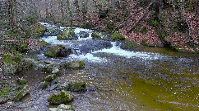 Mountain river, water flowing over rocks and boulders