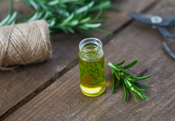 rosemary oil on wooden surface