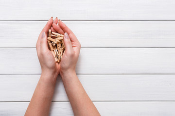 Valentine day background, clothespins in female hands