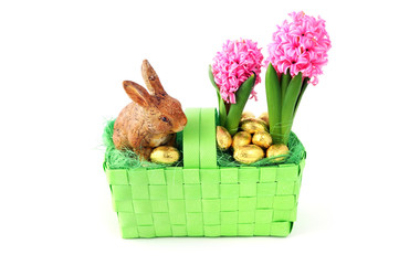 Easter decoration basket with pink hyacinth flower and eggs and rabbit