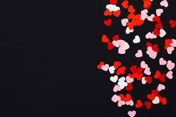 Paper hearts on black background