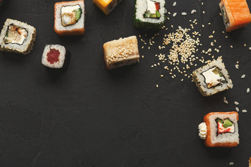 Sushi and rolls background, frame on black, top view.