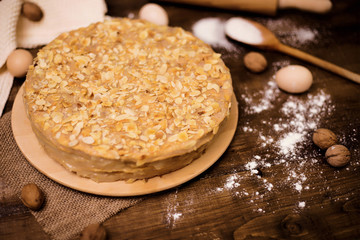 Homemade cake with cream on a wooden surface