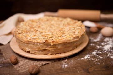 Homemade cake with cream on a wooden surface
