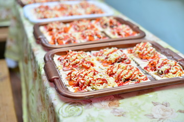 Fresh pizza with tomatoes, cheese and mushrooms on wooden background