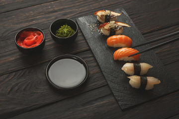 Set of sushi on black wood background, closeup