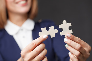 Portrait. Business woman connecting puzzle piece.