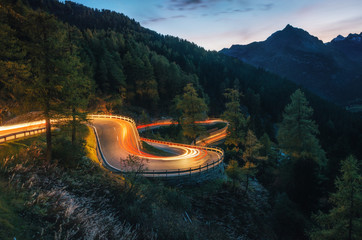 The winding mountain road with light tracks from cars at the evening, Maloja Pass, Switzerland - 187322866