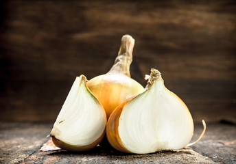 Fresh onions. On wooden background.
