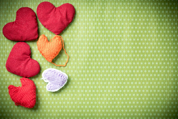 Valentines Day. Colorful knitted hearts on a vintage background in polka dots. Red heart. Green...