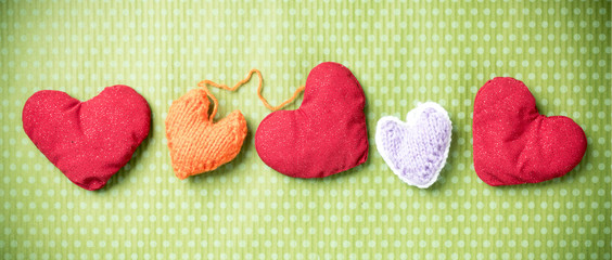 Valentines Day. Colorful knitted hearts on a vintage background in polka dots. Red heart. Green background. Valentine's day. Heart pendant. Valentine cards. Eighth of March. Letter box look