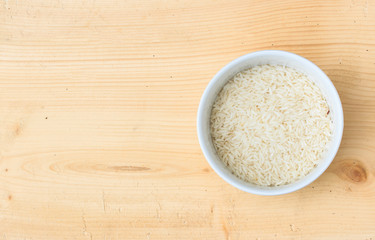 Thai organic rice in bowl on wood background.