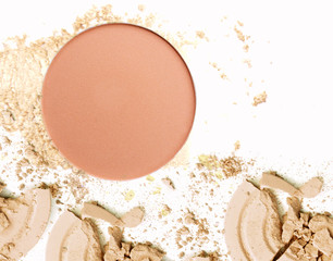 Crushed make up powder. Cosmetic powder crushed on white.