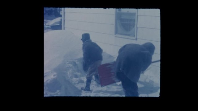 1964 Kids build igloo in snow after blizzard